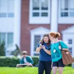 Two students walking outside on campus