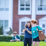 Two students walking outside on campus
