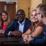 Man leads discussion among associates.