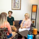 Social worker meeting with two people