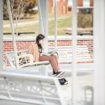 Girl using a laptop outdoors