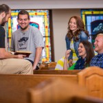 students discuss scripture inside church