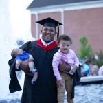 A graduate celebrating with his children