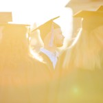 Students wearing cap and gown at sunset