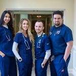 PA students standing together in PA building's hallway. 
