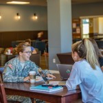 Military cadet speaking with fellow students
