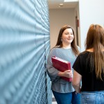 two women talking indoors