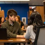 man helps lead a student through a question