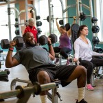 Adults exercising in weight room