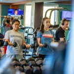 young adults working out in a weight room