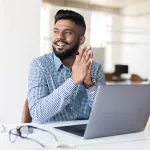 Man sitting at desk with laptop open