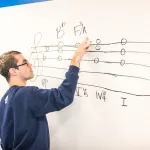 A music student practices music dictation
