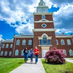 Students walk on campus near HSB