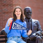 A Cumberlands alumna holds a pennant to display her school spirit. 