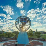 The sun rises behind the globe statue on Cumberlands' campus. 