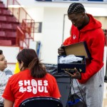 Cumberlands students show a student from a local school a pair of new shoes during Shoes 4 the Soul. 