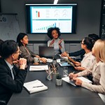 A team of business professionals discuss a plan during a meeting. 