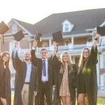 Students share a moment as they prepare for graduation. 