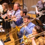 Band students practice a musical selection in the university recital hall. 