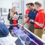Physical therapy students participate in an anatomy exercise with their professor. 