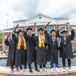 Students celebrate with their diploma following graduation.