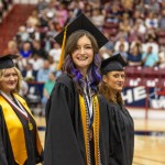 A student walks into her graduation ceremony. 