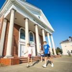 Students walk in front of the chapel on campus.