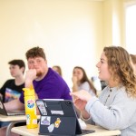 A female student discusses a topic in class. 