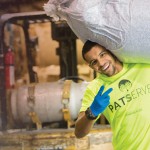 A student carries recycled paper during a service project. 