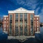 The Rollins Family Learning Center reflecting in the fountain. 