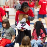 A female college volunteer shows a local female elementary student a new pair of shoes during Cumberlands annual service event. 
