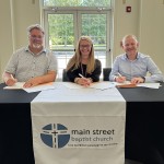 Officials from Main Street Baptist, Williamsburg Independent School, and University of the Cumberlands sign an agreement to operate an early childhood center. 