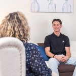 A male student speaks with a counselor during a session at the university's counseling center. 