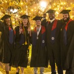 Five students pose in their caps and gowns while holding their diplomas following Cumberlands December graduation ceremony. 