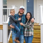 The Perry family poses for a photo in front of a new home constructed by Mountain Outreach. 