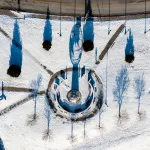 An aerial view of the globe statue on campus after a snow. 