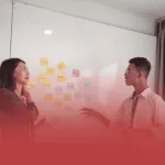 Project Managers Discussing Solutions at a Whiteboard