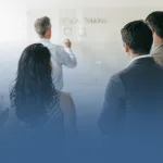 Business Professionals Taking Notes in Meeting