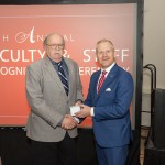 Dr. Tom Frazier is honored at his retirement by President Quentin Young. 