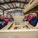 A group of Cumberlands staff members show off a bed they constructed during a service day event.
