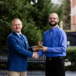 President Young presents a spiritual value award to student Jacob West.