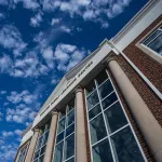 A view of a cloudy sky above the Rollins Family Learning Center. 