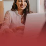 Communications Professional on Laptop with Clients