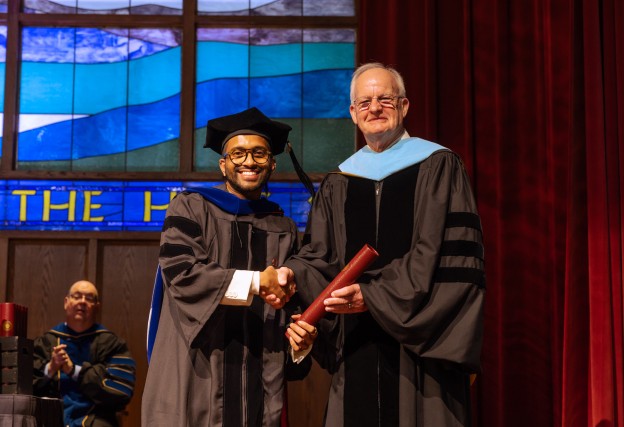 Dr. Sonal Sagar Boda receives his diploma from President Cockrum. 