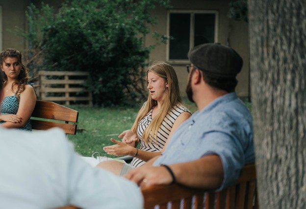 Student Liberty Poley discusses her time at Cumberlands outside in a circle of friends. 