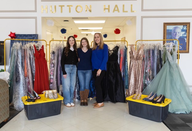 Cumberlands students Ella Edington, Abigail Wynn, and Caitlin Ball pose with prom dresses they have collected to give away to support local high school students. 