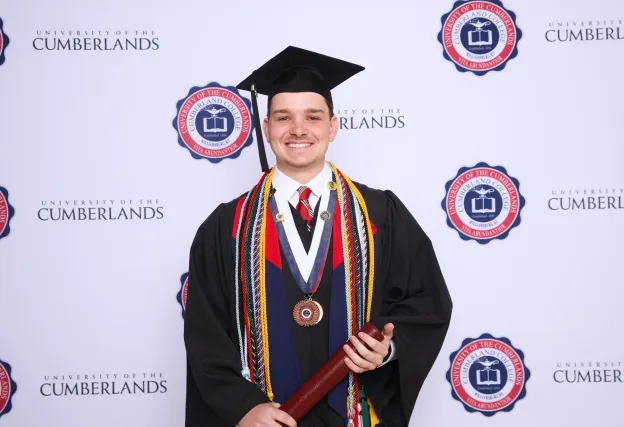 Trey Jackson posing for a graduation photo. 
